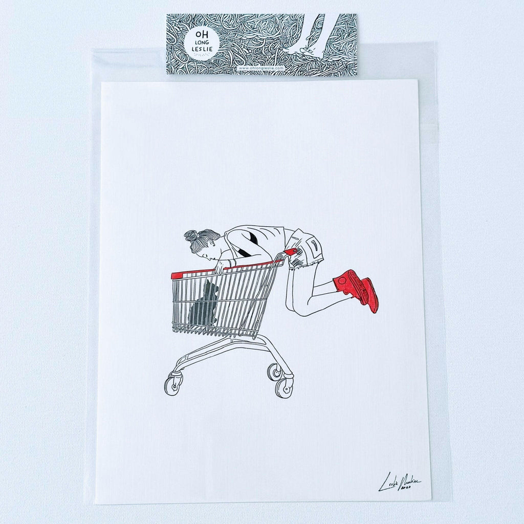 Black Cat in Shopping Cart Art Print by Leslie Molina.