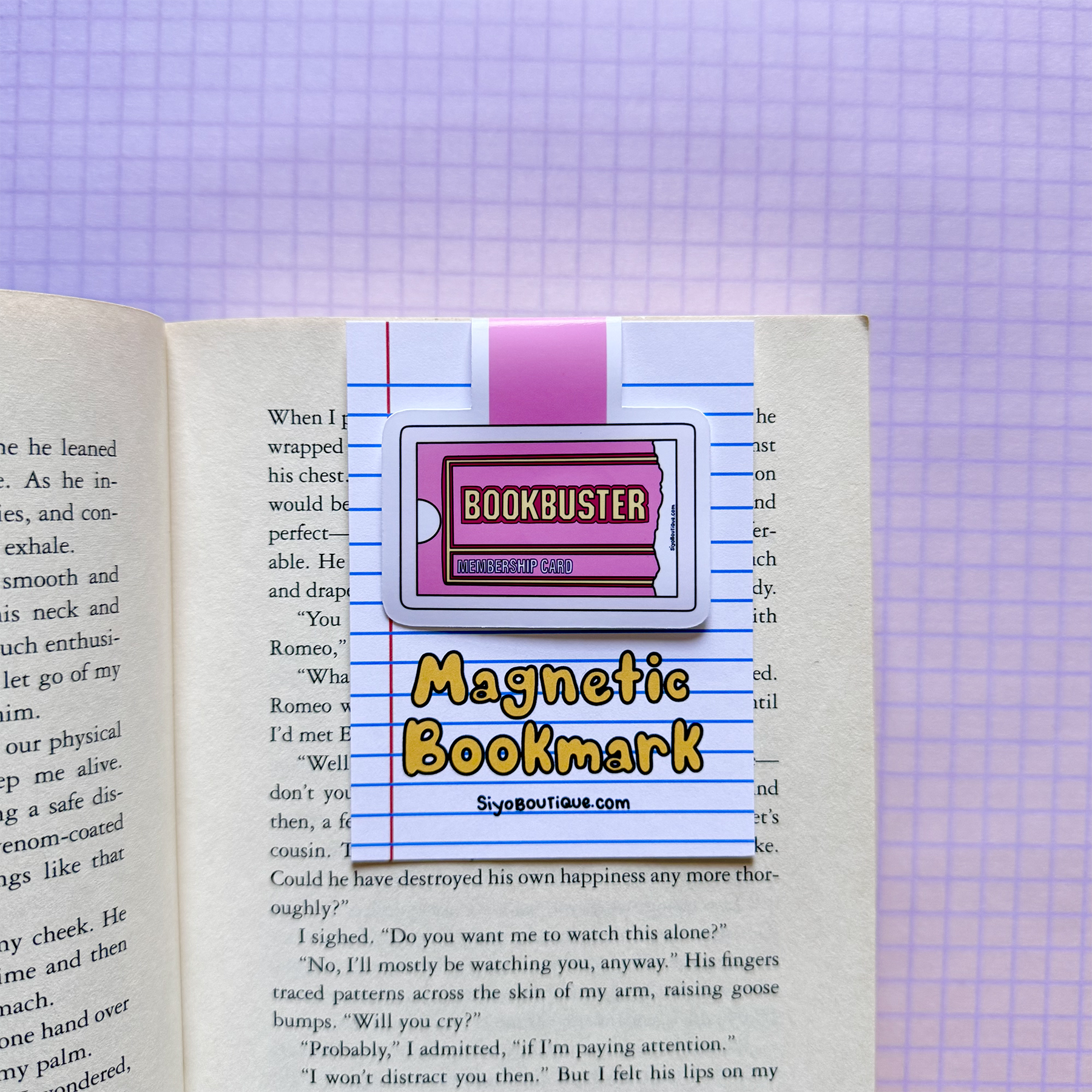 Magnetic bookmark with 'Bookbuster' branding on an open book against a checkered background