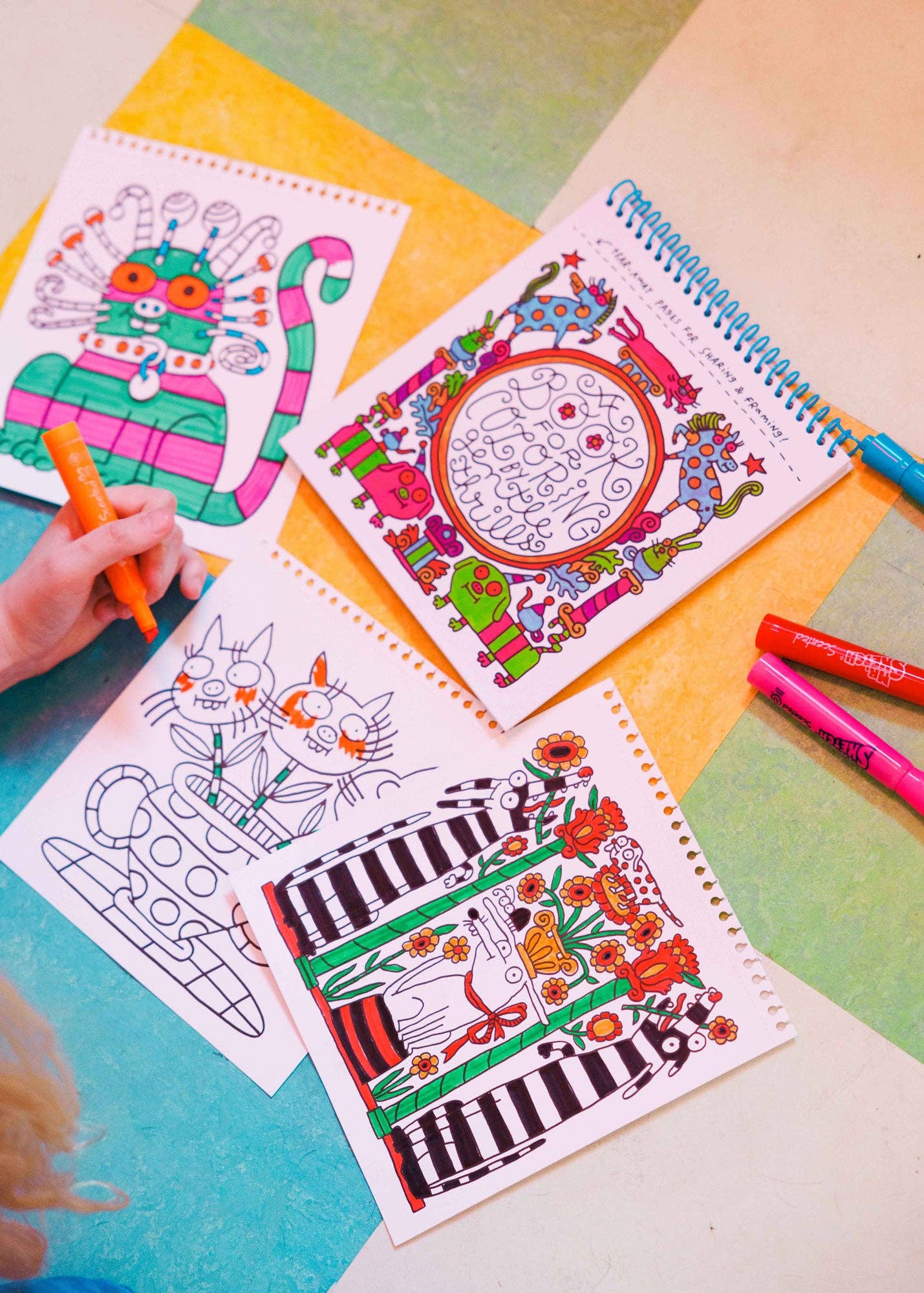 Coloring books with illustrations on a colorful surface