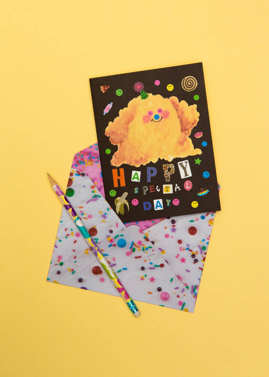 Greeting card with cartoon character and colorful pencil on a yellow background