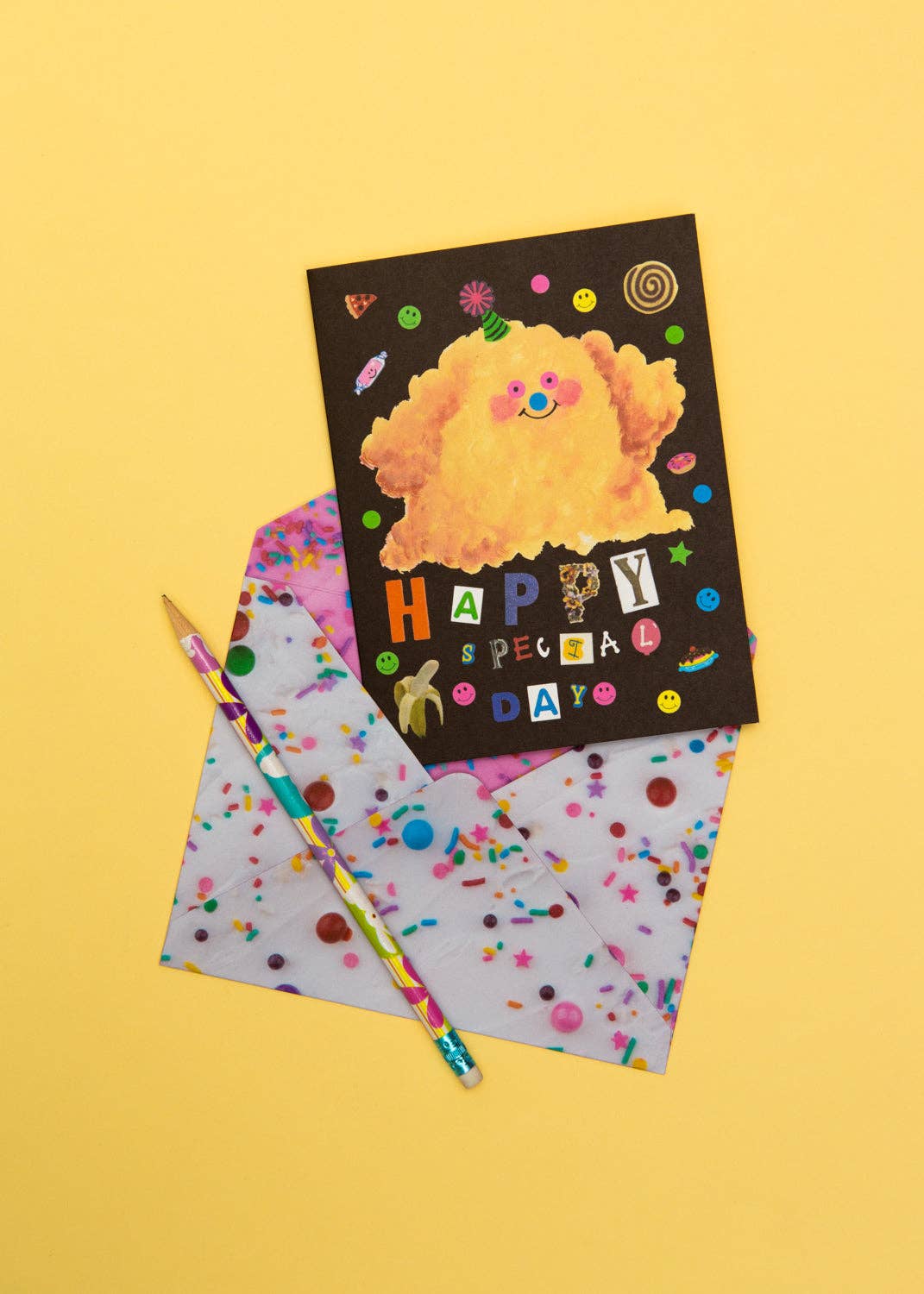 Greeting card with cartoon character and colorful pencil on a yellow background