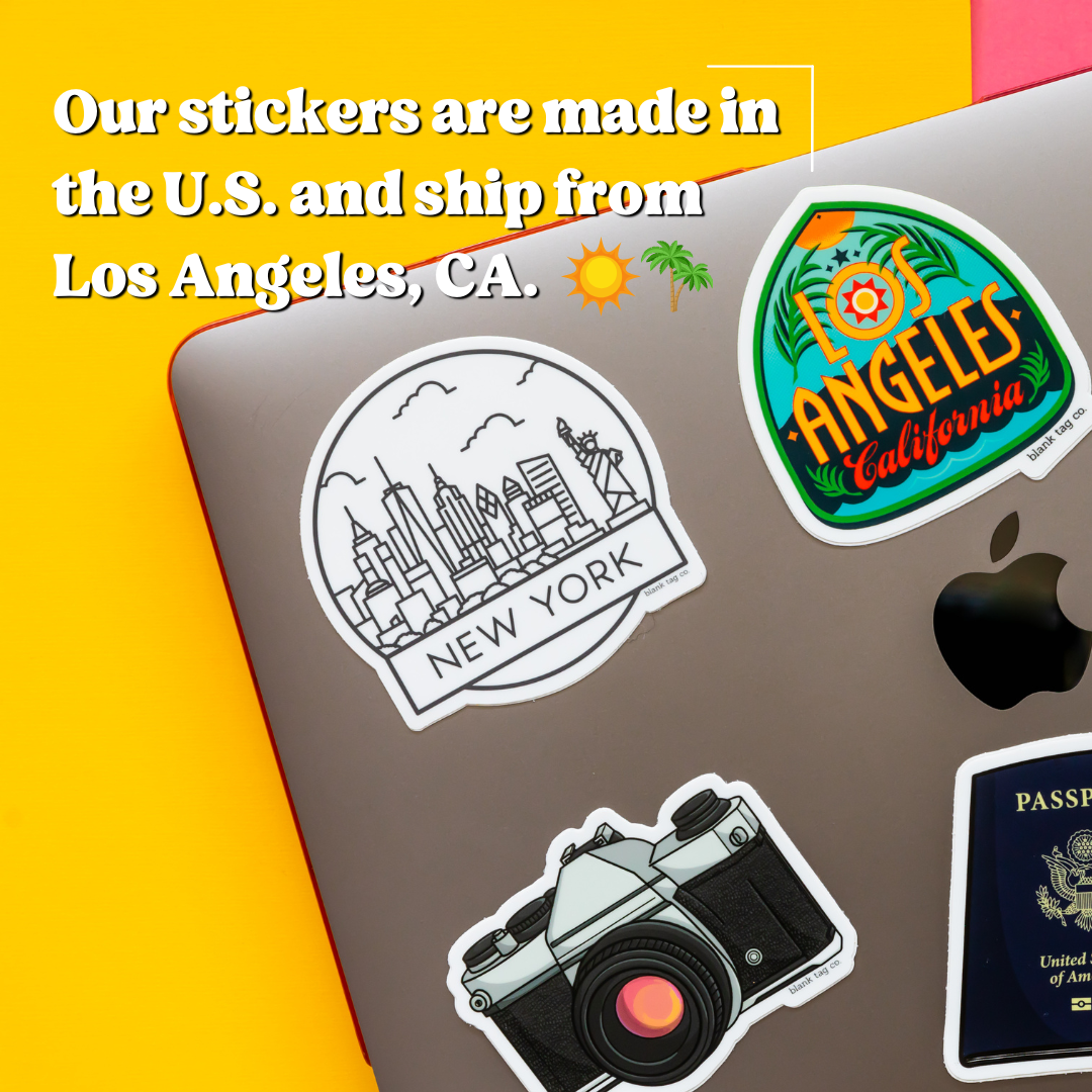 Stickers on a laptop with text about stickers being made in the U.S. and shipped from Los Angeles, CA.